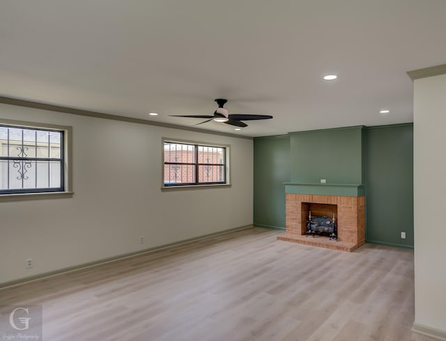808 E St, Minden, LA 71055 - unfurnished living room featuring ceiling fan, light wood finished floors, recessed lighting, a brick fireplace, and baseboards