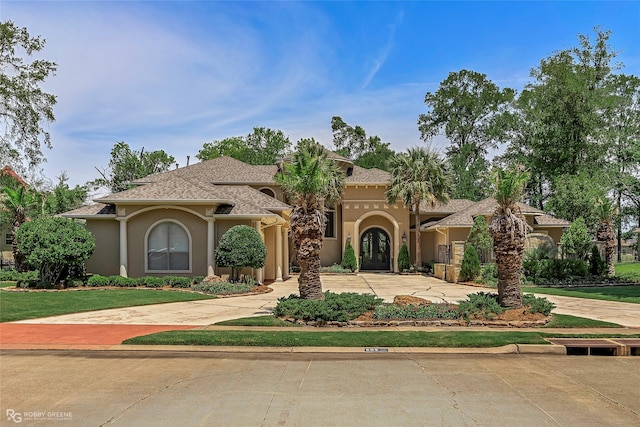 609 Enchanted Ln, Bossier City, LA 71111 - mediterranean / spanish-style house with stucco siding and curved driveway
