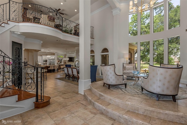609 Enchanted Ln, Bossier City, LA 71111 - entrance foyer featuring a high ceiling, a chandelier, stairway, crown molding, and decorative columns