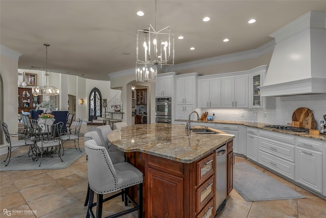 609 Enchanted Ln, Bossier City, LA 71111 - kitchen with a chandelier, a sink, premium range hood, appliances with stainless steel finishes, and crown molding