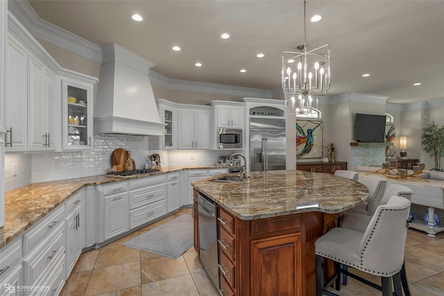 609 Enchanted Ln, Bossier City, LA 71111 - kitchen featuring built in appliances, a sink, custom range hood, backsplash, and glass insert cabinets