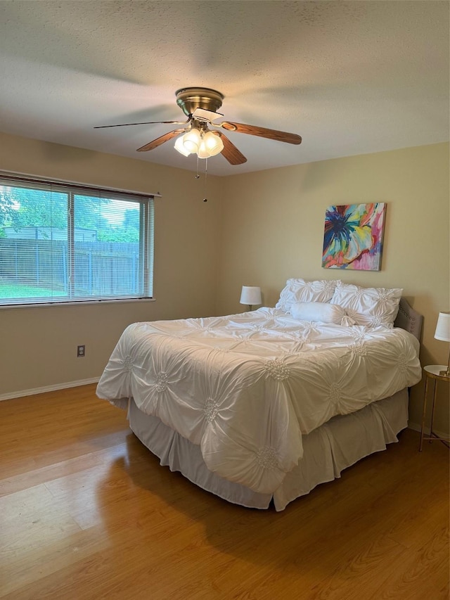 8622 Jackson Square Pl, Shreveport, LA 71115 - bedroom with wood finished floors, baseboards, and a ceiling fan