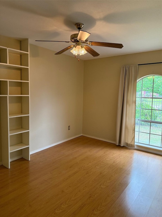 8622 Jackson Square Pl, Shreveport, LA 71115 - spare room with wood finished floors, a ceiling fan, and baseboards