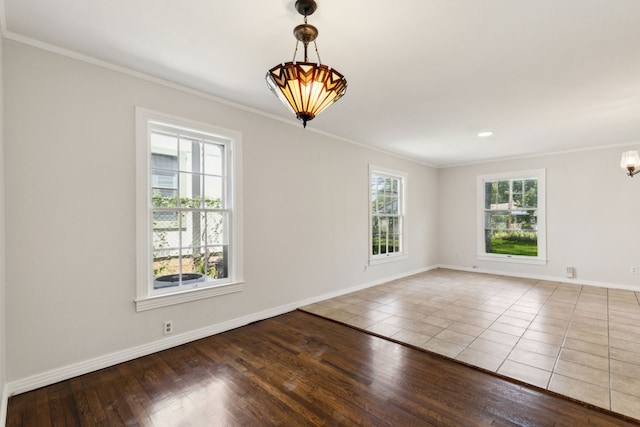4908 Calmont Ave, Fort Worth, TX 76107 - empty room featuring crown molding, baseboards, wood finished floors, and a chandelier