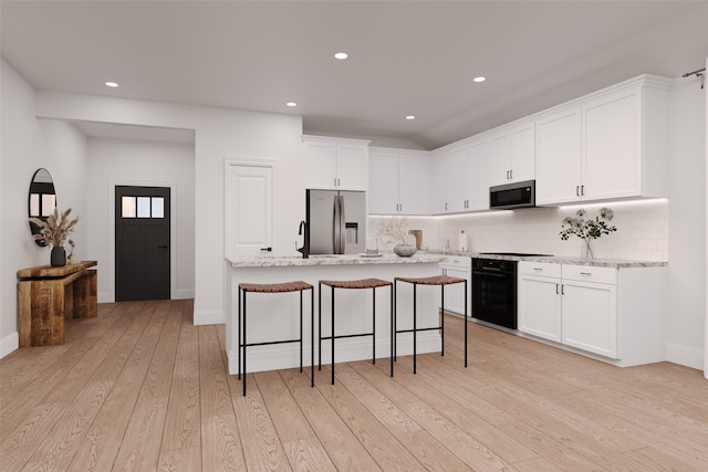 3108 Patrinia St, Royse City, TX 75189 - kitchen with appliances with stainless steel finishes, light wood-style floors, white cabinets, decorative backsplash, and baseboards
