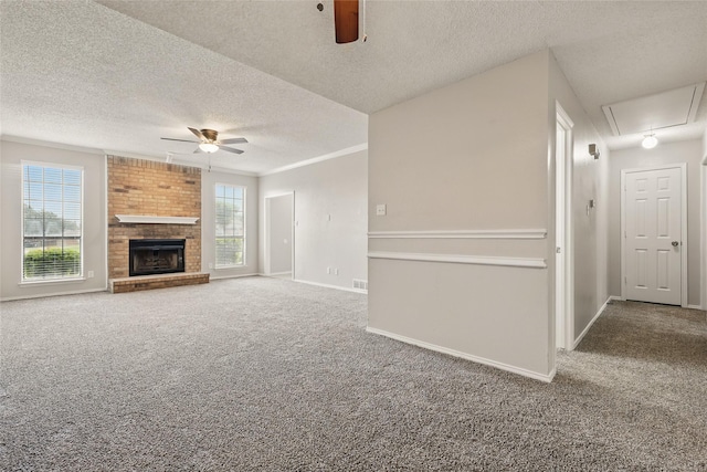 703 Inglewood Trl, Desoto, TX 75115 - unfurnished living room with ceiling fan, attic access, carpet floors, a textured ceiling, and baseboards
