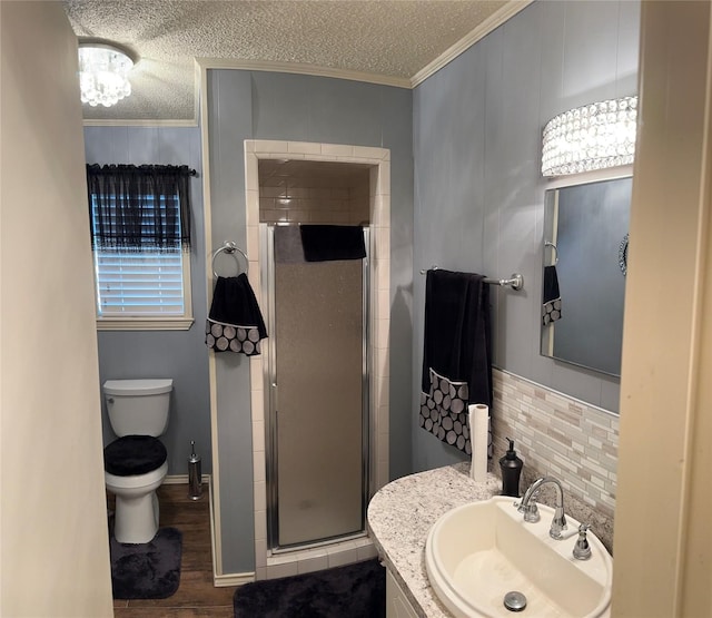 1308 Houston St, Sulphur Springs, TX 75482 - full bath with ornamental molding, a stall shower, wood finished floors, toilet, and a textured ceiling