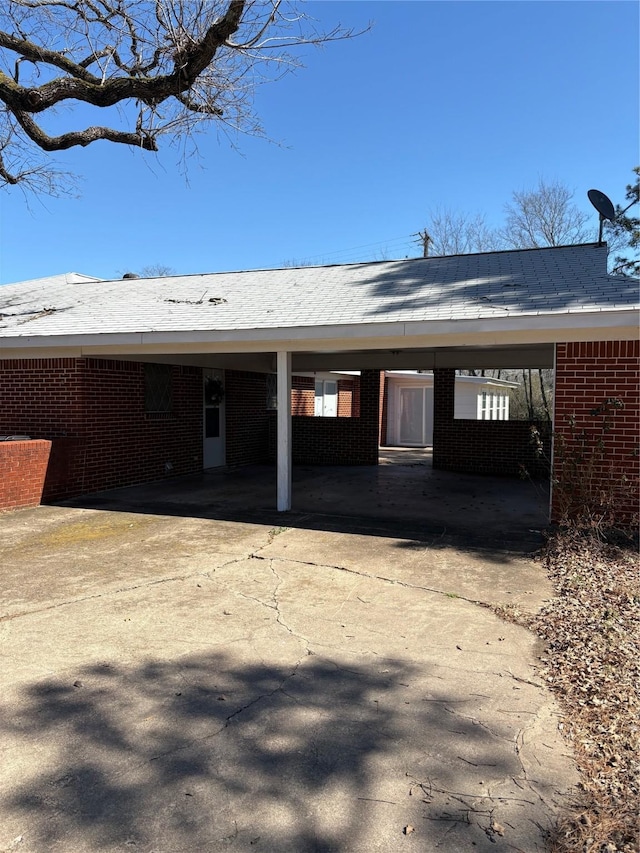 1308 Houston St, Sulphur Springs, TX 75482 - view of front of property featuring driveway, brick siding, and a carport