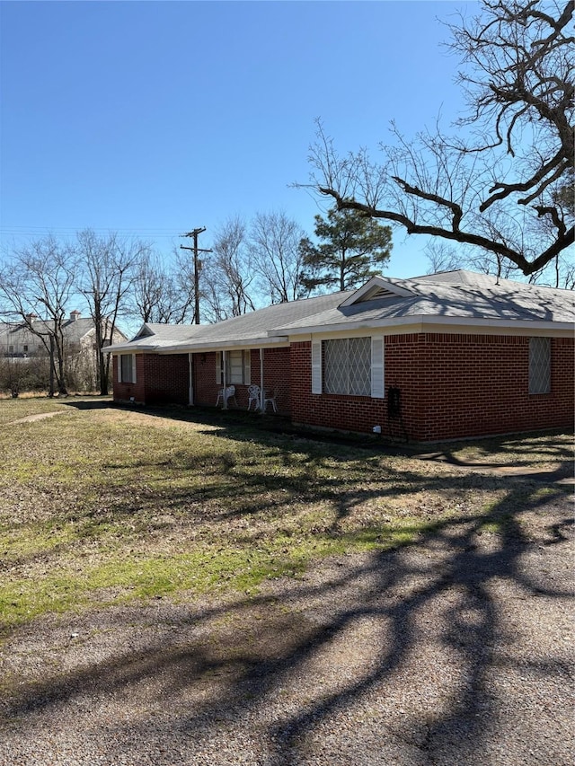 1308 Houston St, Sulphur Springs, TX 75482 - view of property exterior with brick siding and a yard