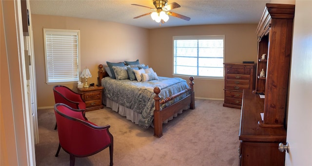 1308 Houston St, Sulphur Springs, TX 75482 - bedroom featuring light carpet, a textured ceiling, baseboards, and a ceiling fan