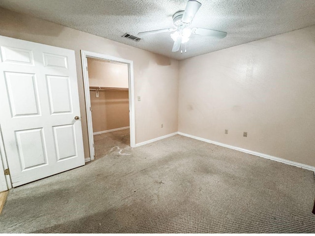 5215 Colonial Ave, Dallas, TX 75215 - unfurnished bedroom featuring a walk in closet, carpet, a textured ceiling, baseboards, and a closet