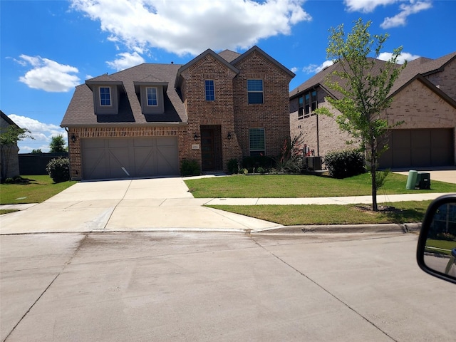 4905 Shadetree St, Little Elm, TX 76227 - view of front facade featuring brick siding, concrete driveway, a front yard, a garage, and roof with shingles