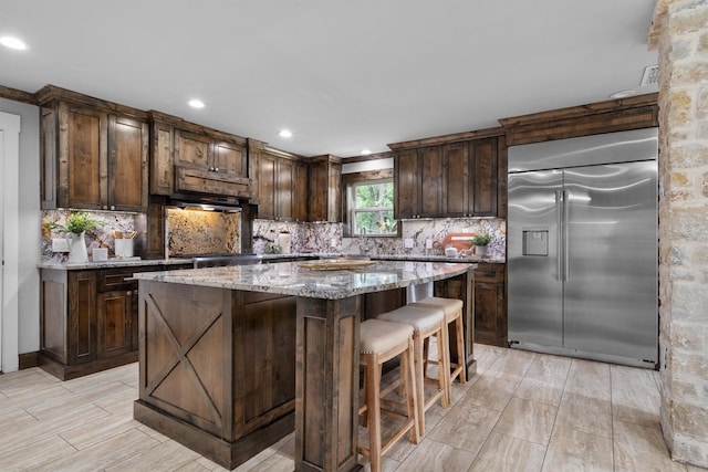 6501 Hillcrest Rd, Flower Mound, TX 75022 - kitchen with stainless steel refrigerator with ice dispenser, decorative backsplash, dark brown cabinetry, and recessed lighting