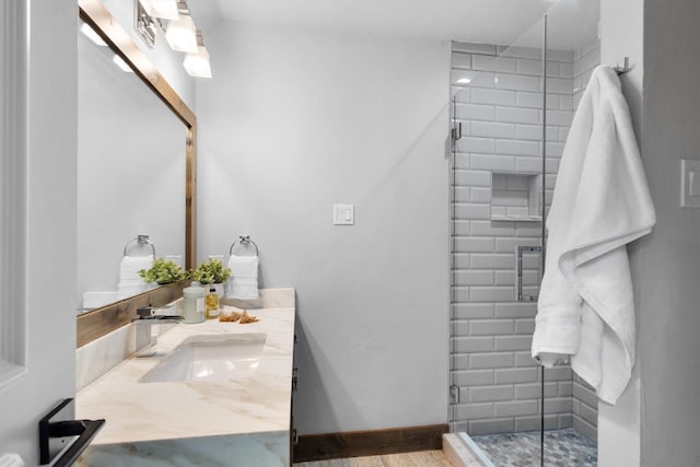 6501 Hillcrest Rd, Flower Mound, TX 75022 - full bathroom with vanity, a stall shower, wood finished floors, and baseboards