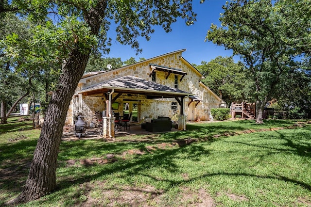6501 Hillcrest Rd, Flower Mound, TX 75022 - rear view of house with stone siding, a yard, stairway, a patio, and an outdoor hangout area