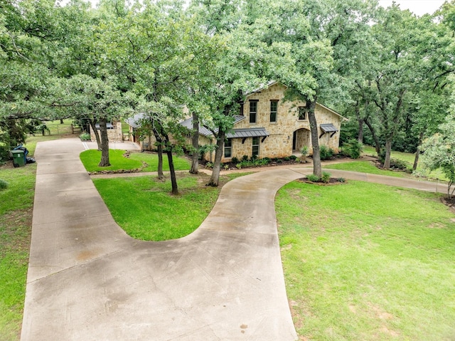 6501 Hillcrest Rd, Flower Mound, TX 75022 - view of front of property with curved driveway, a standing seam roof, a front lawn, stone siding, and metal roof