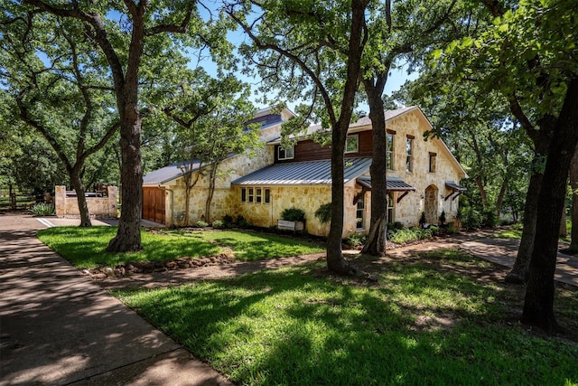 6501 Hillcrest Rd, Flower Mound, TX 75022 - view of side of home with a standing seam roof, stone siding, and metal roof