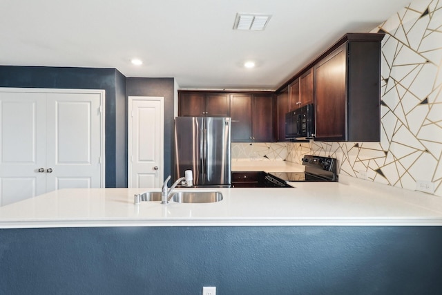 5431 Longshadow Dr, Princeton, TX 75407 - kitchen with black appliances, a sink, dark brown cabinetry, tasteful backsplash, and light countertops