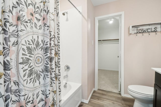 5431 Longshadow Dr, Princeton, TX 75407 - bathroom with wood finished floors, toilet, vanity, a walk in closet, and shower / tub combo with curtain