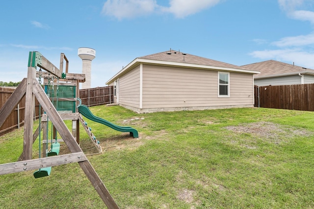 5431 Longshadow Dr, Princeton, TX 75407 - back of house featuring a playground and roof with shingles
