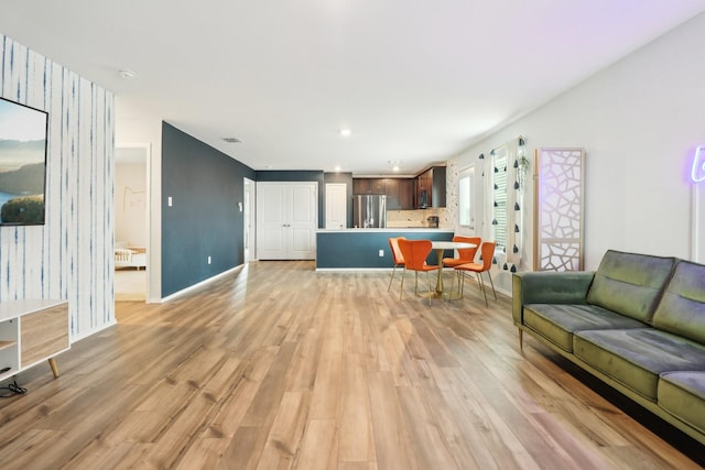 5431 Longshadow Dr, Princeton, TX 75407 - living room featuring light wood-style flooring, baseboards, wallpapered walls, and recessed lighting
