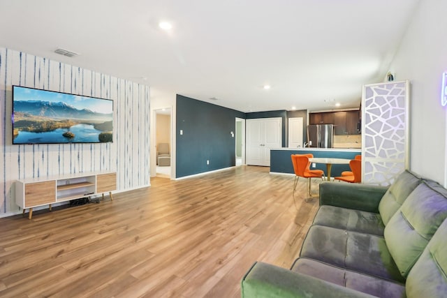 5431 Longshadow Dr, Princeton, TX 75407 - living area with wallpapered walls, an accent wall, light wood-style floors, baseboards, and recessed lighting