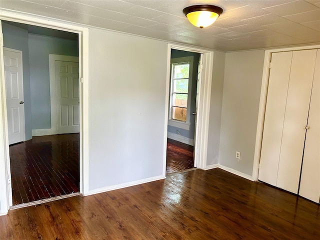 2927 Regent St, Shreveport, LA 71109 - unfurnished bedroom with baseboards, wood finished floors, and a closet