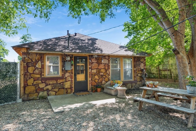 812 N 32nd St, Waco, TX 76707 - back of house with stone siding and roof with shingles