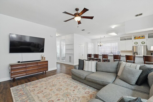 4516 Ridgepointe Dr, The Colony, TX 75056 - living area with a chandelier, a ceiling fan, baseboards, and dark wood finished floors
