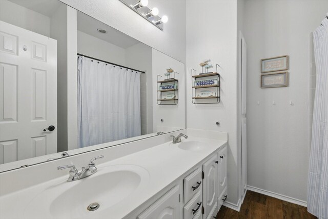 4516 Ridgepointe Dr, The Colony, TX 75056 - full bathroom featuring wood finished floors, double vanity, and baseboards