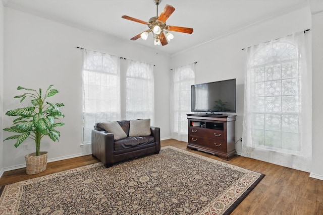 4516 Ridgepointe Dr, The Colony, TX 75056 - living room with a ceiling fan, wood finished floors, and baseboards
