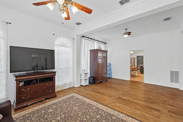 4516 Ridgepointe Dr, The Colony, TX 75056 - living area featuring a ceiling fan, wood finished floors, crown molding, and healthy amount of natural light