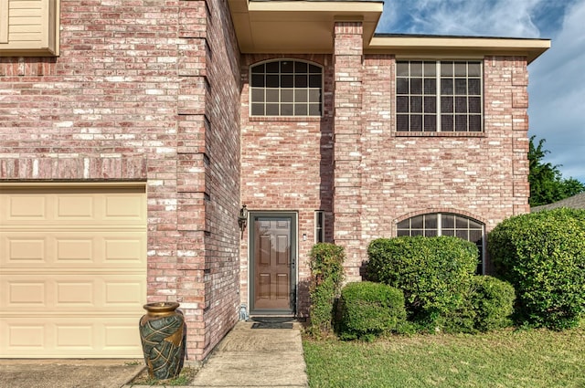 1505 Yellowbird Ct, Desoto, TX 75115 - view of exterior entry featuring brick siding and a garage