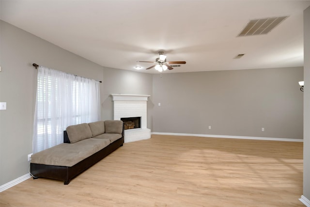 1505 Yellowbird Ct, Desoto, TX 75115 - living area with ceiling fan, light wood finished floors, baseboards, and a brick fireplace