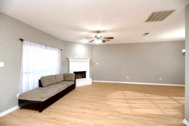 1505 Yellowbird Ct, Desoto, TX 75115 - living room with ceiling fan, light wood-type flooring, and a brick fireplace