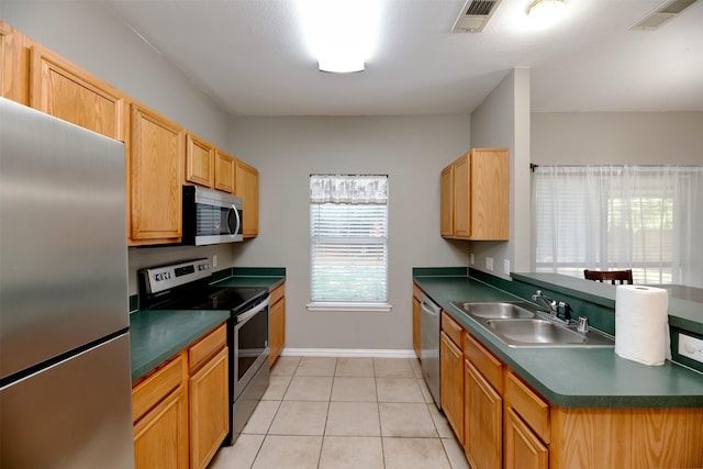 1505 Yellowbird Ct, Desoto, TX 75115 - kitchen with stainless steel appliances, a sink, dark countertops, light tile patterned flooring, and baseboards