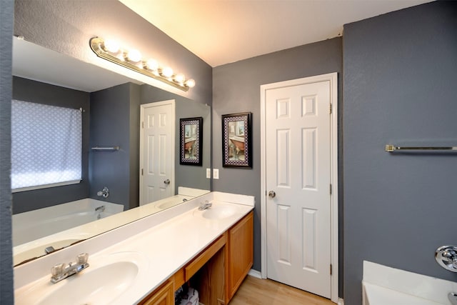 1505 Yellowbird Ct, Desoto, TX 75115 - full bathroom featuring double vanity, a bath, and wood finished floors
