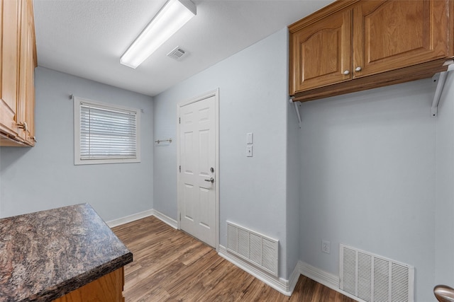 621 S Ruidoso Downs Dr, Robinson, TX 76706 - laundry room featuring wood finished floors and baseboards