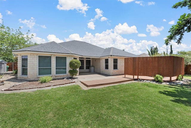 621 S Ruidoso Downs Dr, Robinson, TX 76706 - back of house with a patio area, roof with shingles, stone siding, and a shed