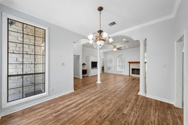 621 S Ruidoso Downs Dr, Robinson, TX 76706 - unfurnished living room featuring ceiling fan, a fireplace, wood finished floors, baseboards, and arched walkways