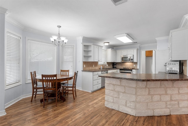 621 S Ruidoso Downs Dr, Robinson, TX 76706 - kitchen featuring stainless steel appliances, dark countertops, open shelves, a sink, and a peninsula