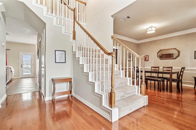 1418 Harmony Ln, Carrollton, TX 75006 - stairway featuring wood-type flooring, baseboards, and crown molding