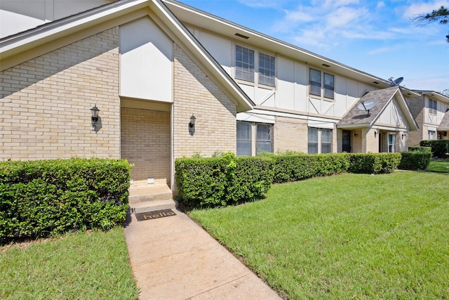 1905 W Morton St Unit 6, Denison, TX 75020 - view of front of property with a front yard, brick siding, and board and batten siding