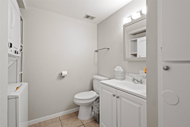 1905 W Morton St Unit 6, Denison, TX 75020 - bathroom with vanity, tile patterned floors, toilet, stacked washer / dryer, and baseboards