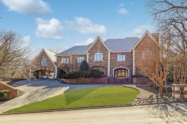 1708 Deepdale Dr, Westover Hills, TX 76107 - colonial house with driveway, a chimney, a front lawn, and brick siding