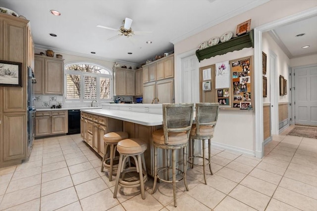 1708 Deepdale Dr, Westover Hills, TX 76107 - kitchen featuring light tile patterned floors, a center island, crown molding, light countertops, and a breakfast bar