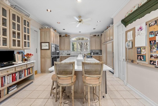 1708 Deepdale Dr, Westover Hills, TX 76107 - kitchen with light tile patterned floors, a ceiling fan, light countertops, a kitchen bar, and ornamental molding