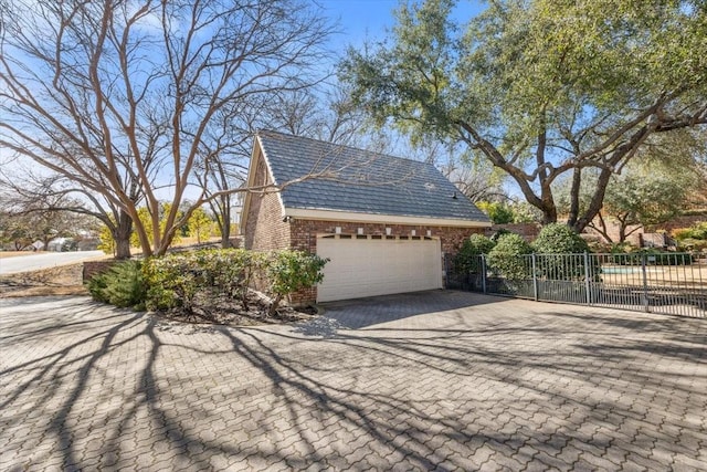 1708 Deepdale Dr, Westover Hills, TX 76107 - view of home's exterior with decorative driveway, brick siding, and an attached garage