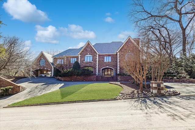 1708 Deepdale Dr, Westover Hills, TX 76107 - georgian-style home with driveway, a chimney, a front lawn, and brick siding