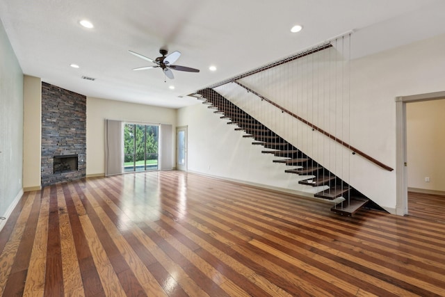3804 Mattison Ave, Fort Worth, TX 76107 - unfurnished living room featuring hardwood / wood-style floors, a ceiling fan, a stone fireplace, recessed lighting, and stairway